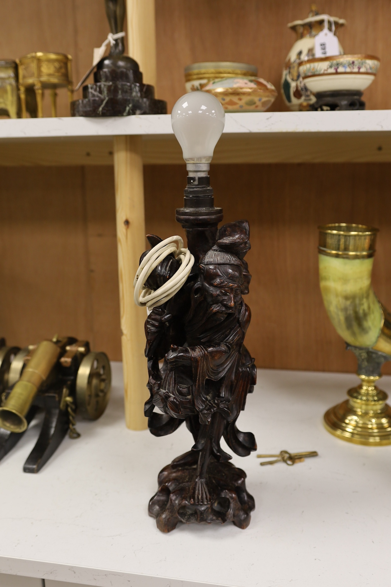 A Chinese carved wooden figural table lamp base, 36cm high not including light fitting. Condition - rubbed in places